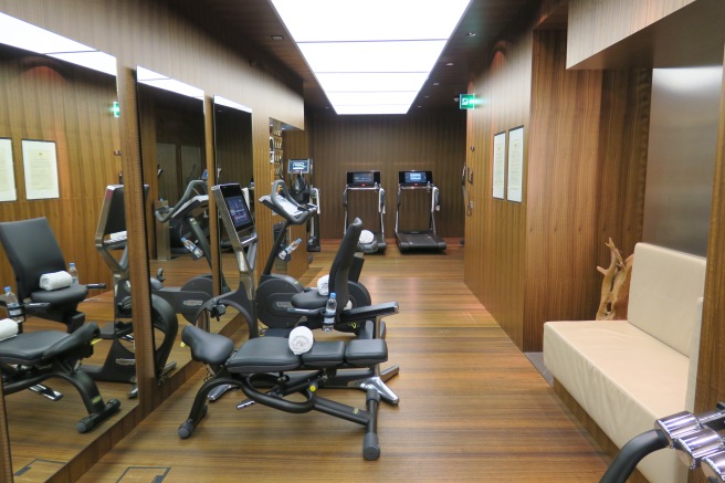 a room with exercise machines and mirrors