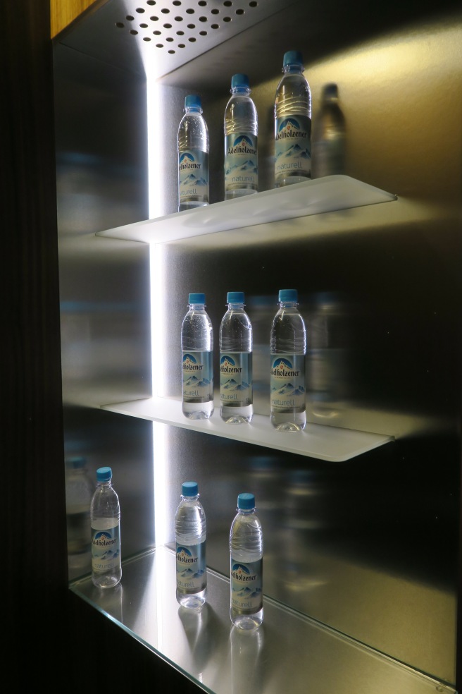 a group of water bottles on shelves