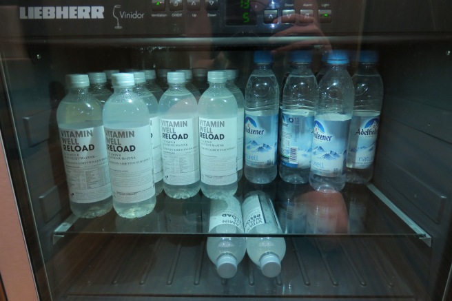 a group of bottles in a refrigerator