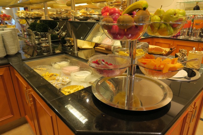 a buffet table with fruit in bowls