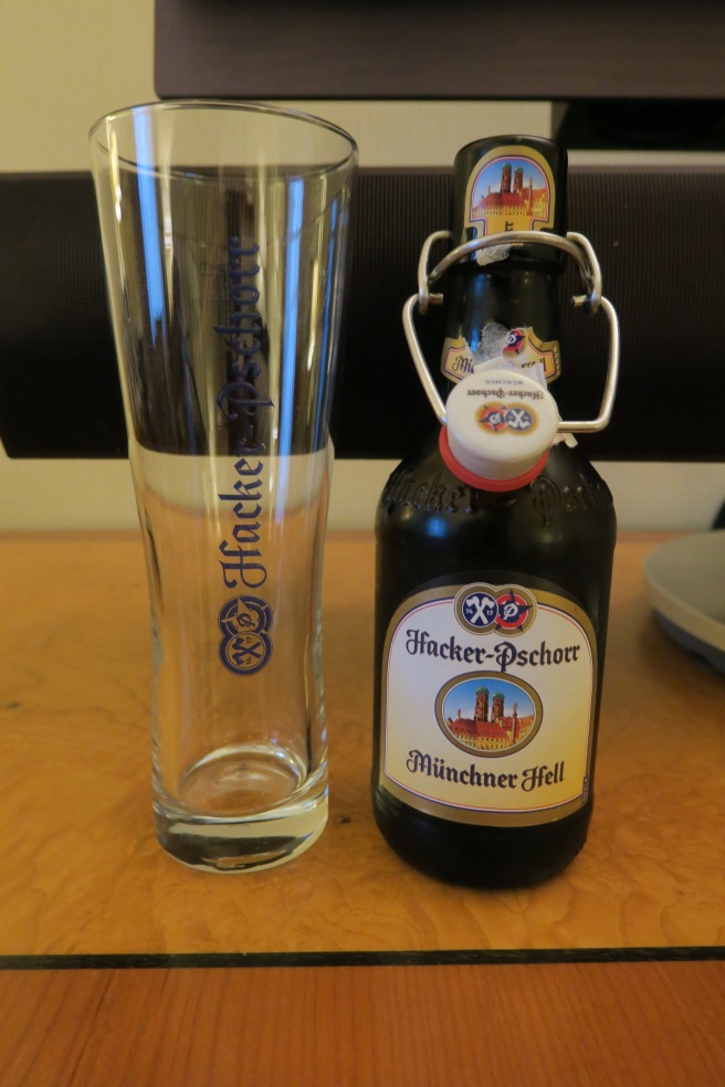 a bottle of beer next to a glass