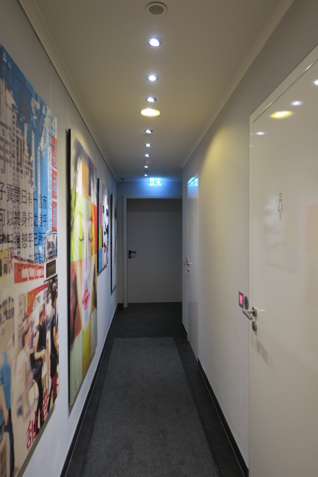 a hallway with posters on the wall