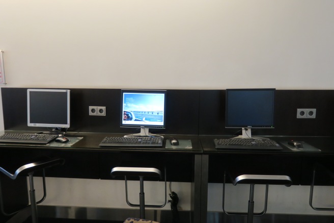 a row of computers on a desk
