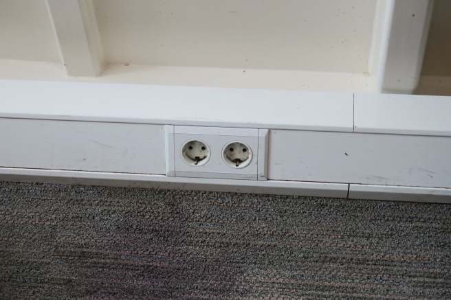 a white rectangular object with two outlets