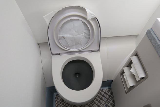 a toilet with a tissue paper in the lid