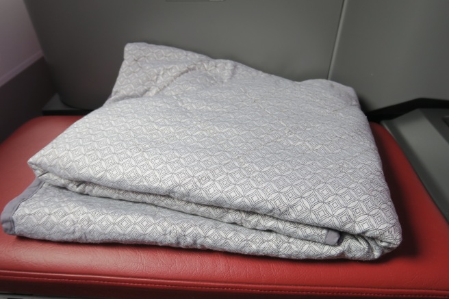 a blanket on a red seat