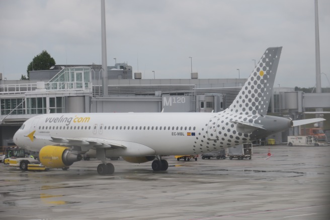 a white and yellow airplane on a tarmac