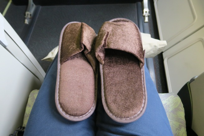 a pair of slippers on a person's lap