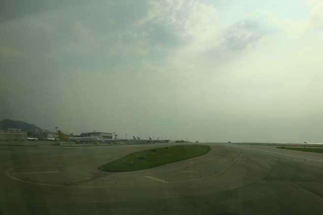 an airport runway with planes in the background