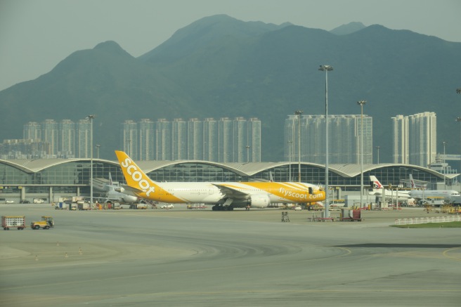 a large yellow and white airplane on a runway