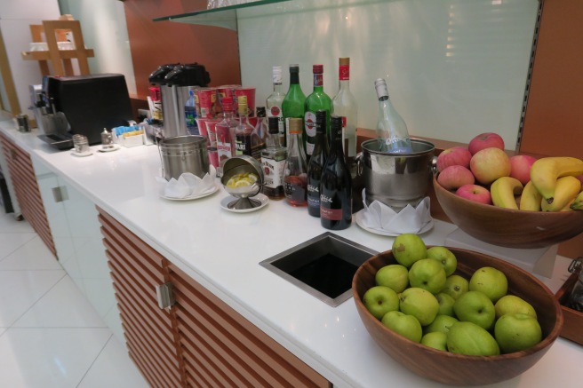 a counter with fruit and bottles