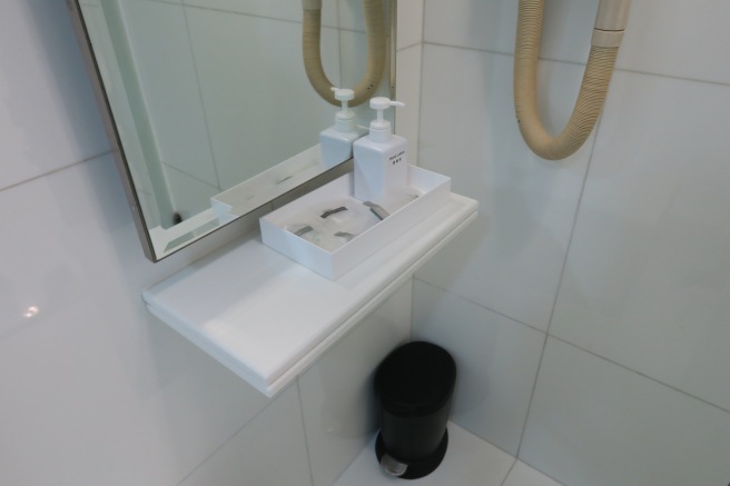 a bathroom with a mirror and a soap dish