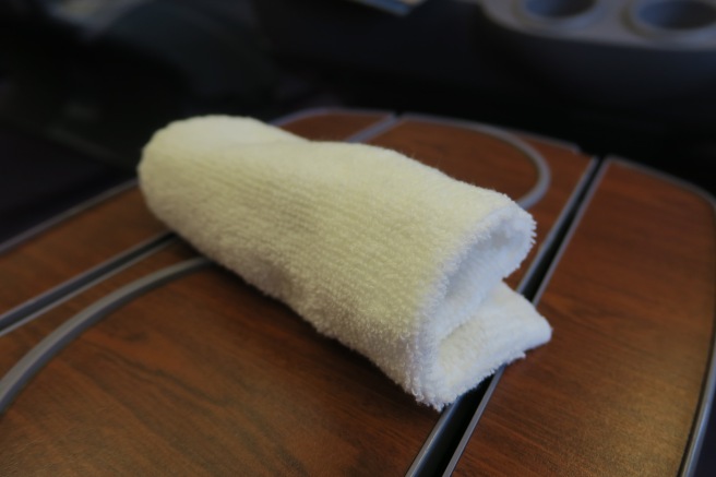 a white towel on a wood surface