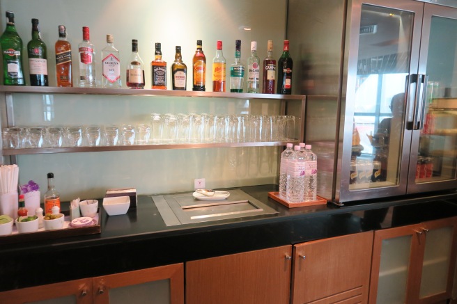 a bar with bottles of alcohol and glasses