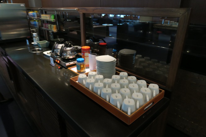a tray of white cups and plates on a counter
