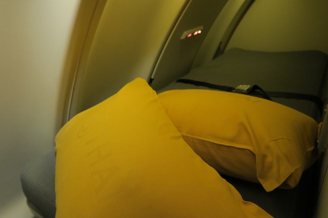 a yellow pillows on a bed