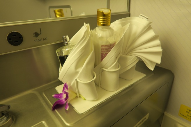 a bottle of perfume and a towel on a counter