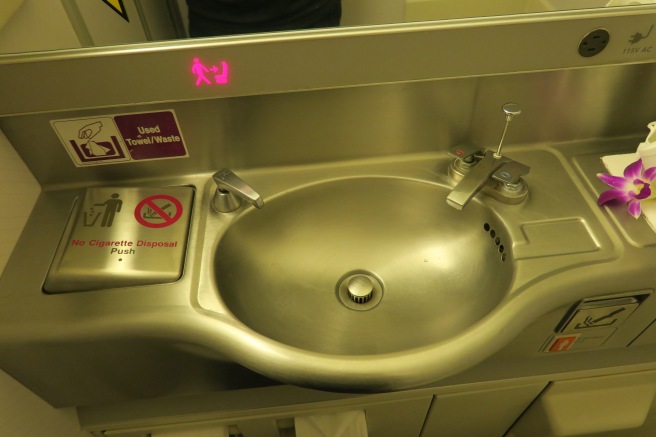 a sink with a pink sign