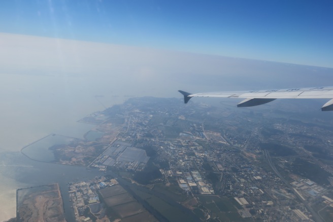 an airplane wing and land below