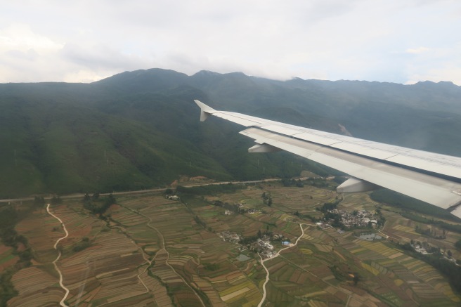 an airplane wing over a landscape