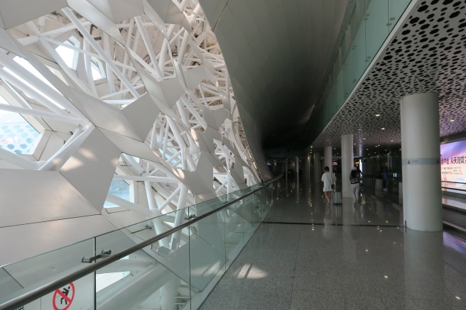 a white structure with a glass railing