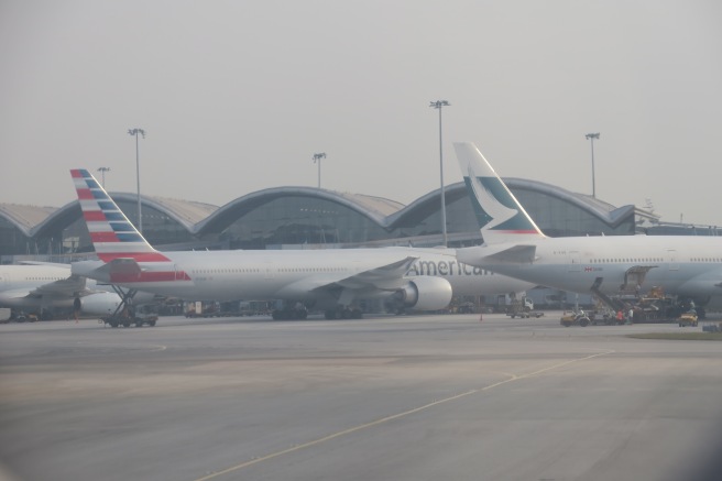 a couple of airplanes parked at an airport