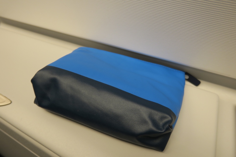 a blue and black bag on a white surface