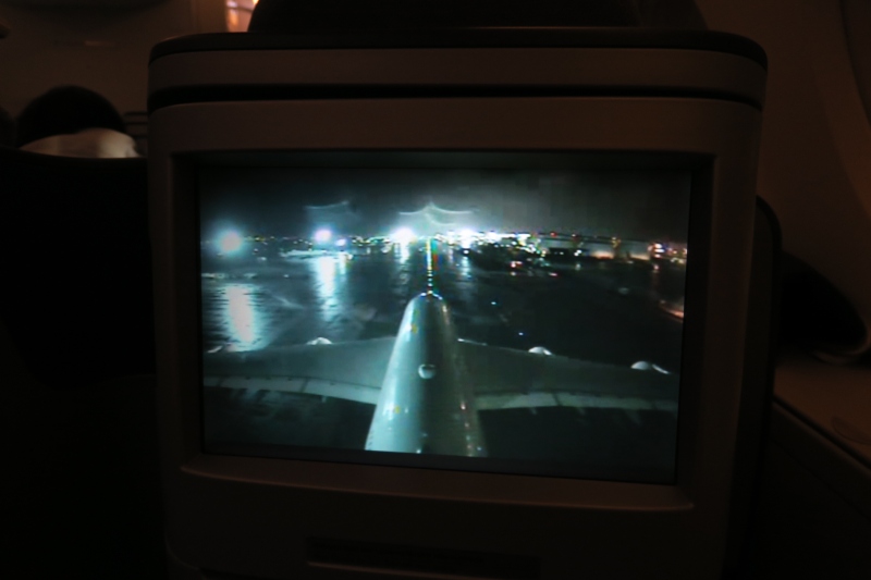 a screen with an airplane wing and lights on it
