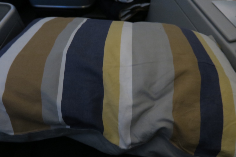 a striped pillow on a plane