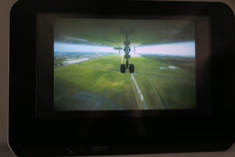 a screen with a plane landing on the ground