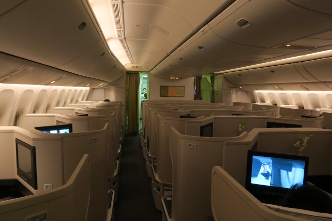 an airplane with rows of seats and monitors