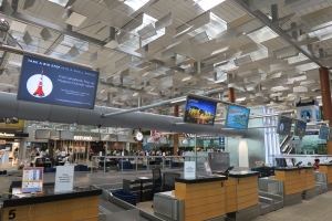 a large airport terminal with a few monitors