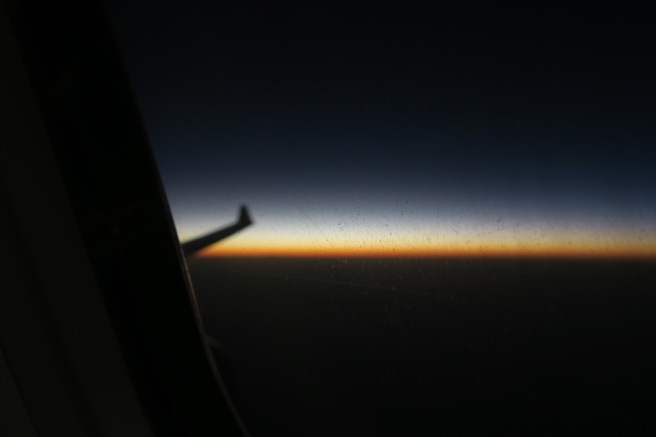 a view of the sunset from an airplane window