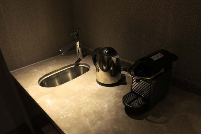 a sink and a coffee maker on a counter