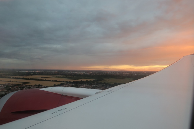an airplane wing with a sunset in the background