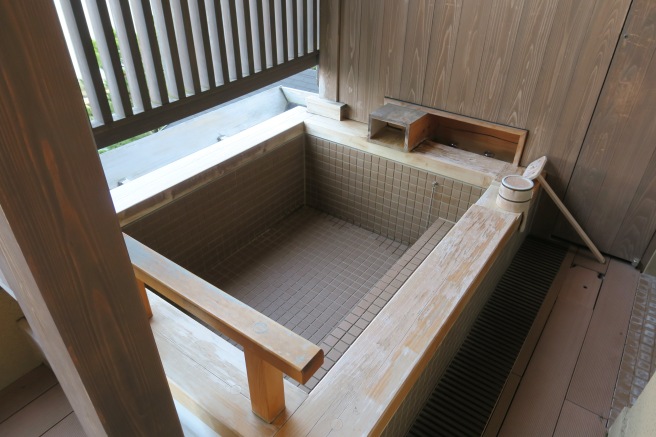 a wooden tub with a wooden railing