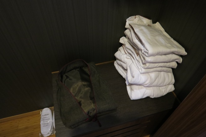 a stack of white clothes on a table