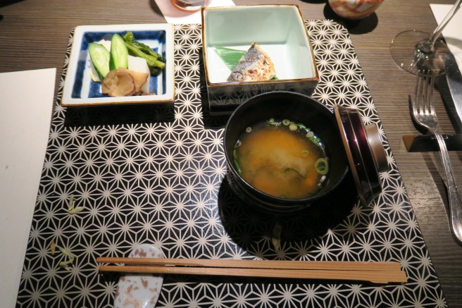 a bowl of soup and other dishes on a table