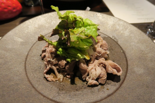 a plate of food with a green leaf on top
