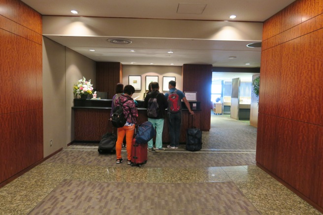 a group of people standing in a hotel lobby