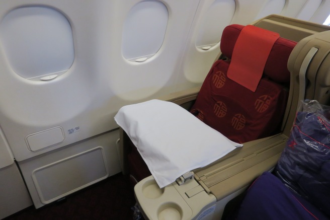 a seat with a pillow and a pillow on the side of the seat