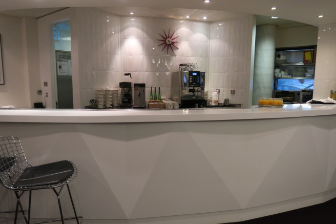 a counter with drinks and coffee machines