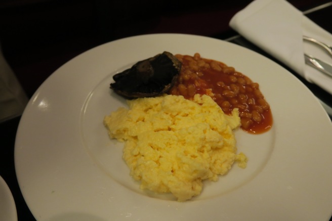 a plate of food with eggs and beans
