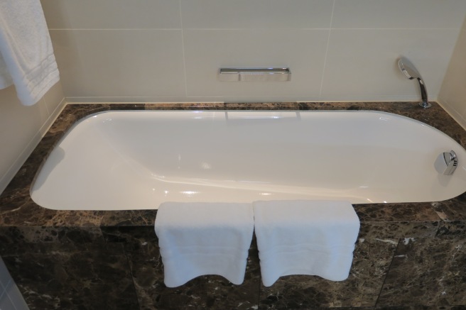 a bathtub with white towels on it