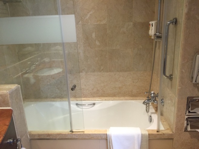 a bathtub with a glass door