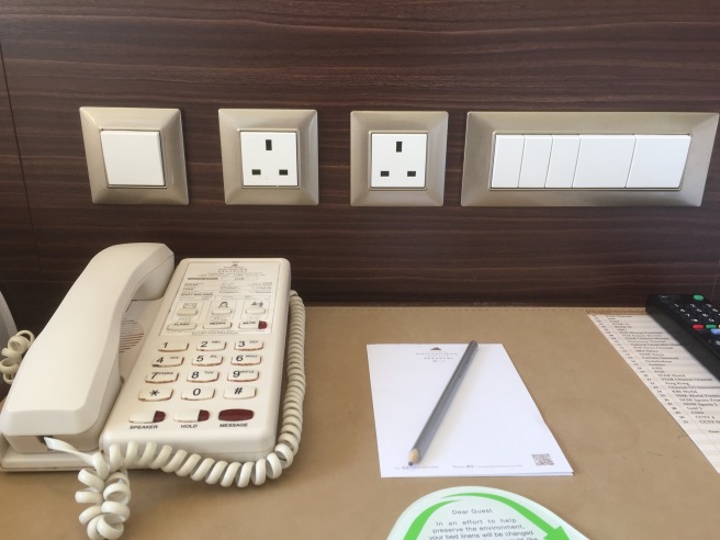 a telephone and a pencil on a desk