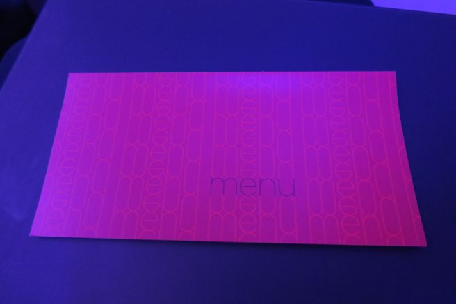 a pink rectangular menu on a blue surface