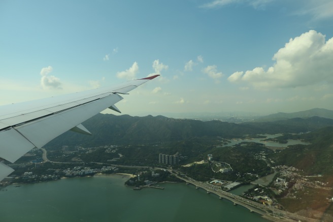 an airplane wing over a body of water