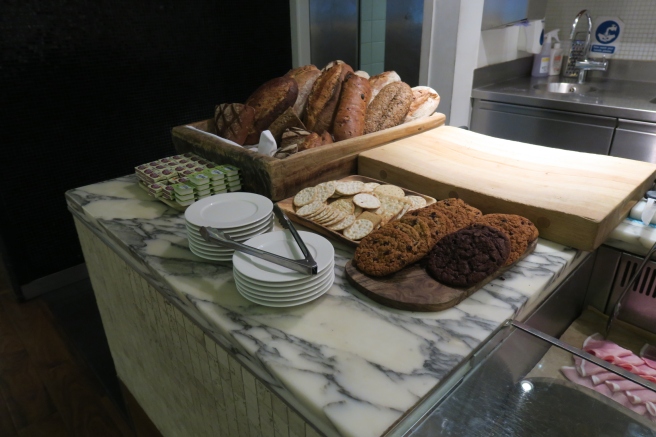 a counter with plates and bread on it