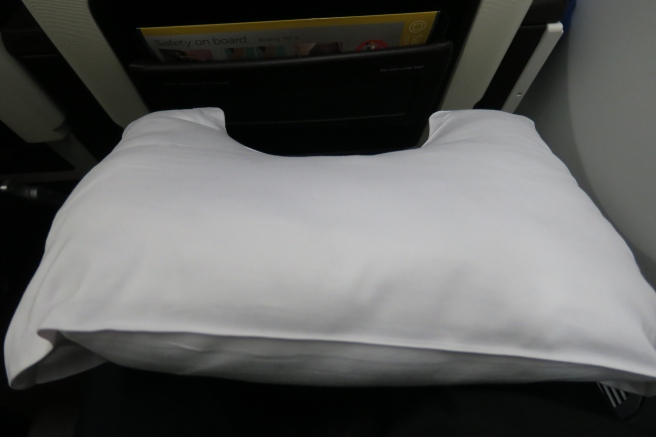 a white pillow on a black surface